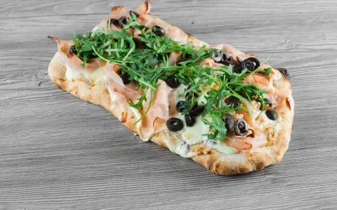 Pyszna pinsa z szynką, mozzarellą, rukolą i oliwkami. Idealna na szybki obiad, jak z przepisu na pinsa z Lidla.
